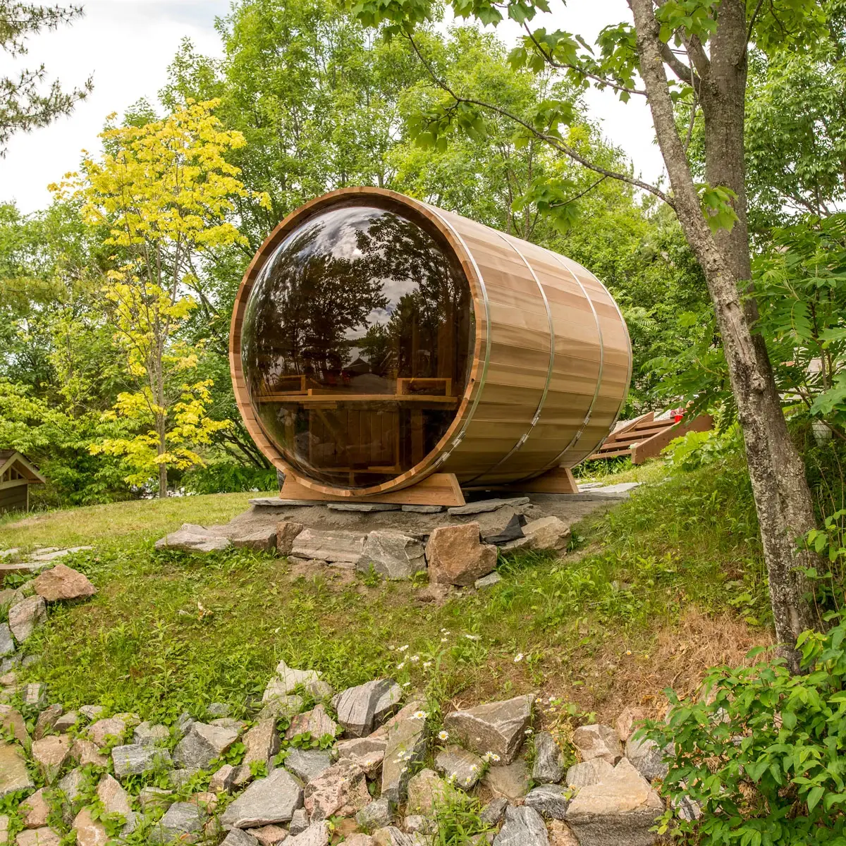 Modern outdoor sauna with large glass front and dark wood exterior